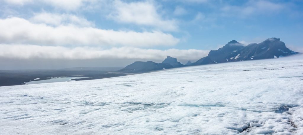 ice sheet stretching toward distant mountains