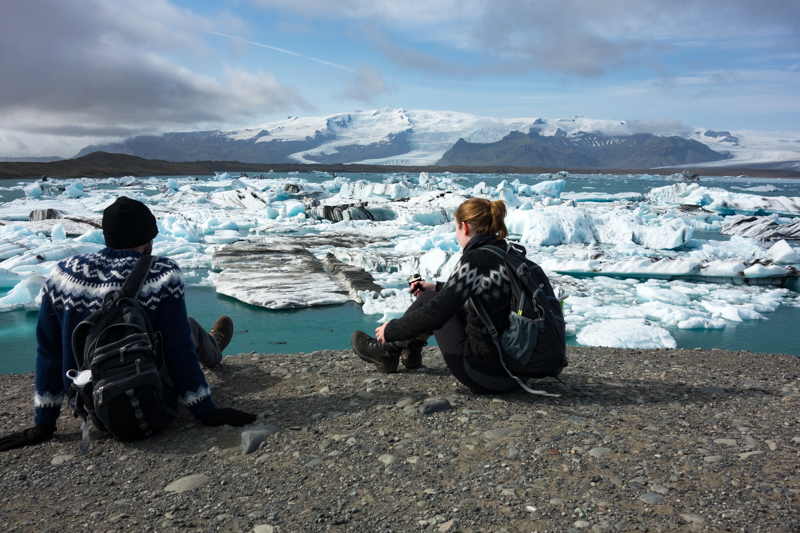 A couple viewing a glacial lagoon