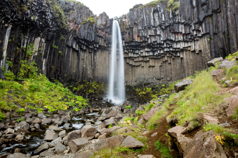 waterfall surrounded by columnar basalt