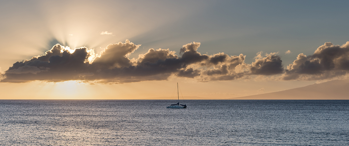 sun setting behind clouds